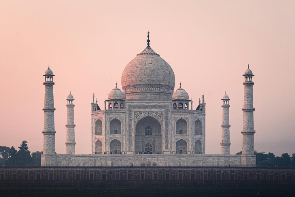Beautiful view of the Taj Mahal at sunrise, showcasing its stunning architecture and historical significance.
